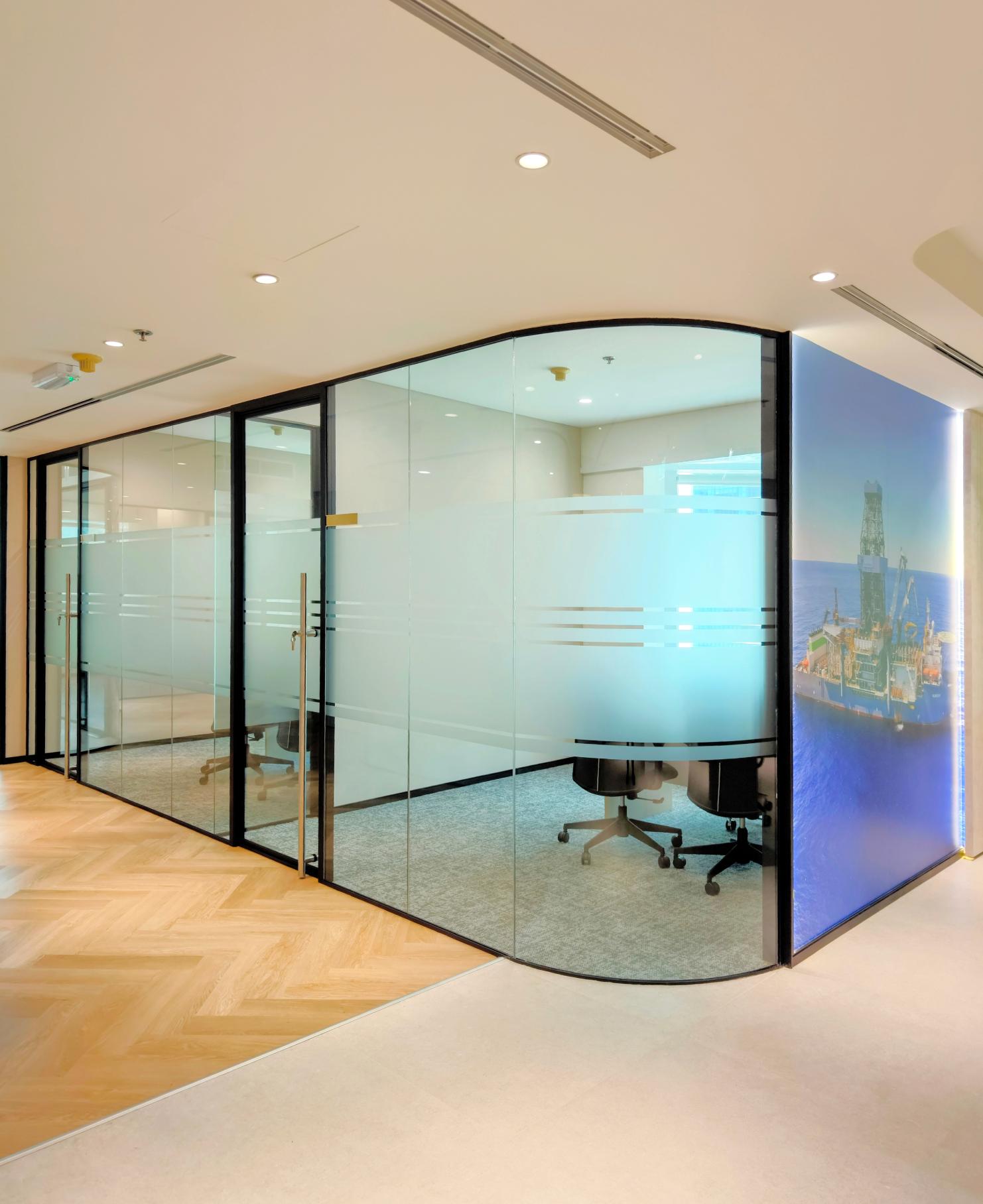Modern office meeting room with curved glass partitions and premium glass works in Dubai at Valaris