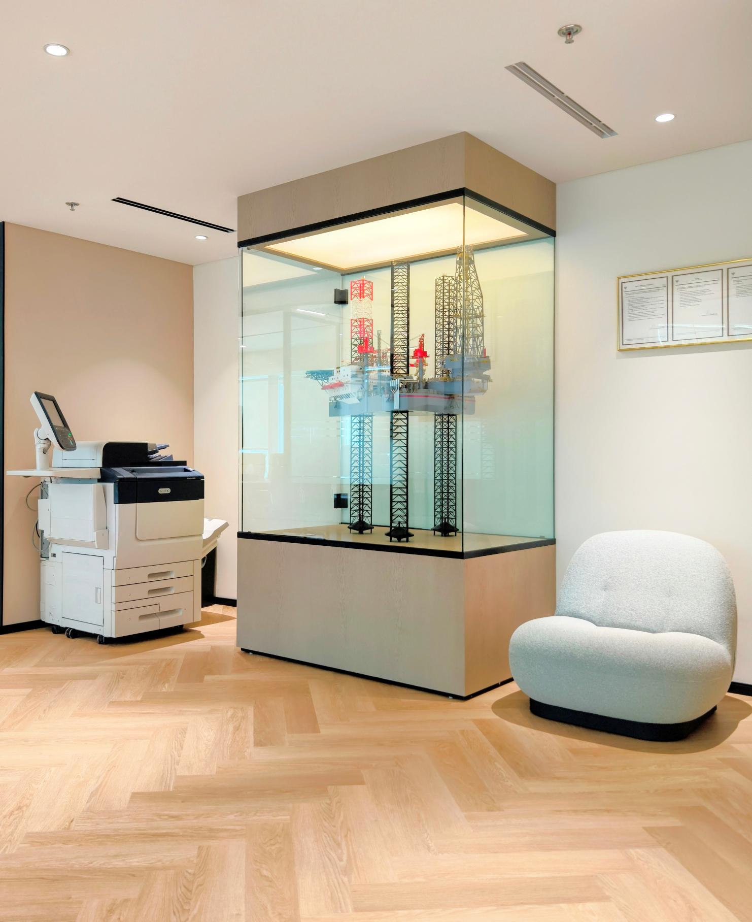 Display unit with architectural model and glass enclosure in modern Valaris Dubai office featuring premium glass works