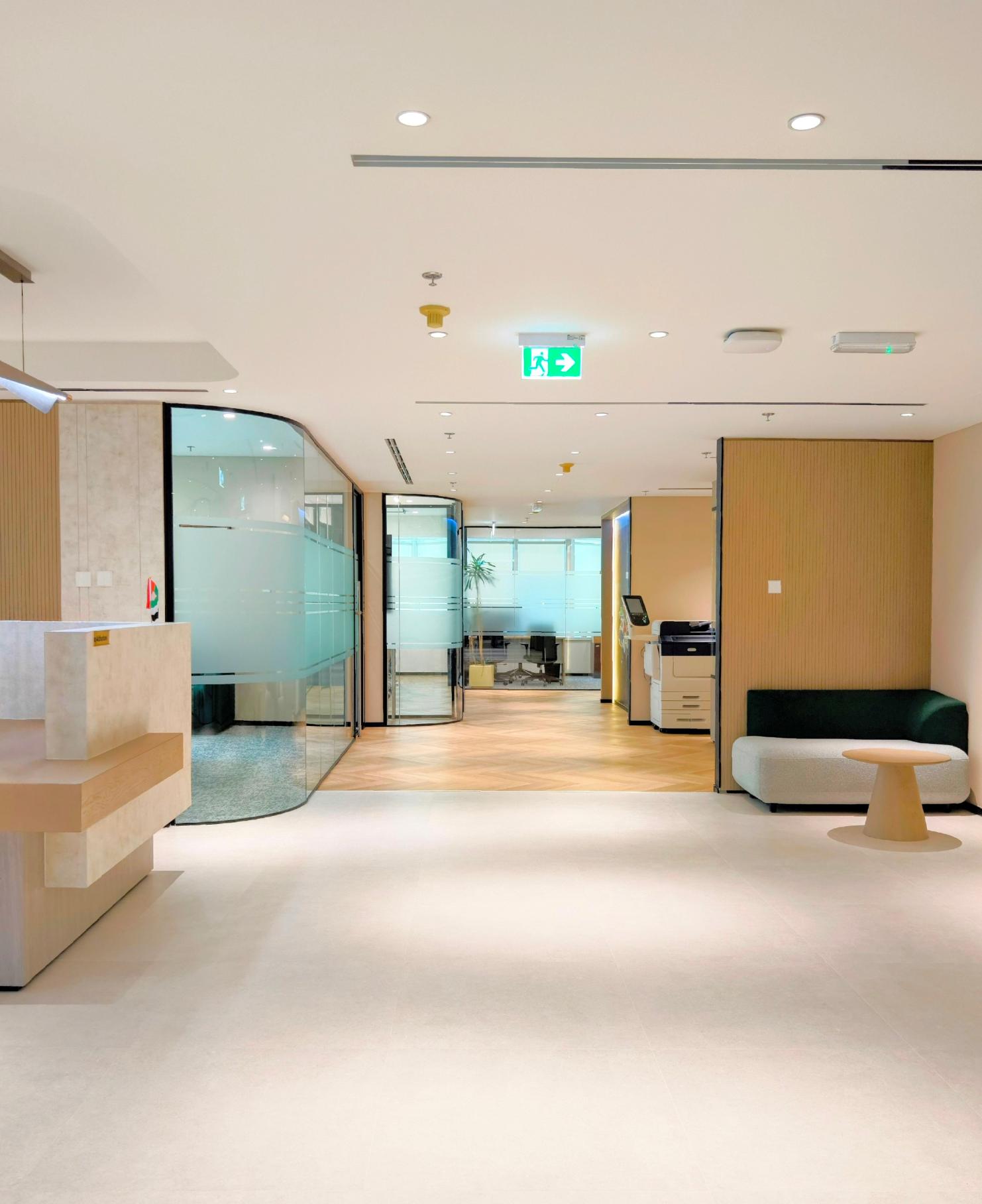 Modern office interior featuring custom joinery works in Dubai with wooden wall panels and glass partitions at Valaris